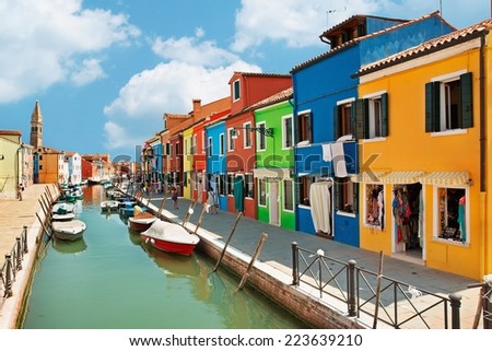 Burano island canal, colorful houses and boats, Italy. 