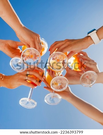 cheers with glasses. summer cocktails with friends on the background of the sky Royalty-Free Stock Photo #2236393799