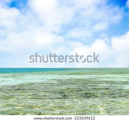 turquoise sea against the sky with clouds