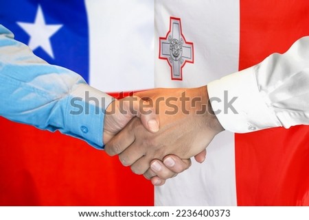Business handshake on background of two flags. Men handshake on background of Chile flag and flag of Malta. Support concept