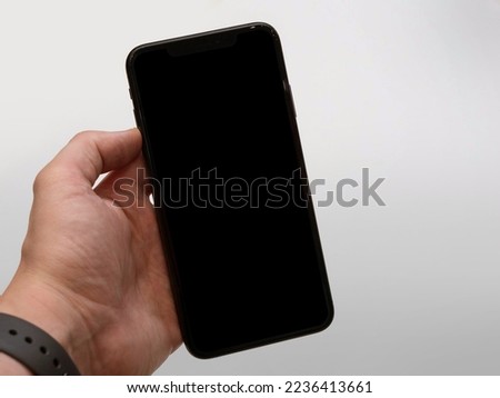 blank screen smartphone using in hand - blank screen mobile phone  Royalty-Free Stock Photo #2236413661
