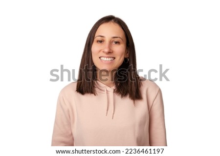 Portrait of a young woman wearing light pink hoodie and smiling to camera.