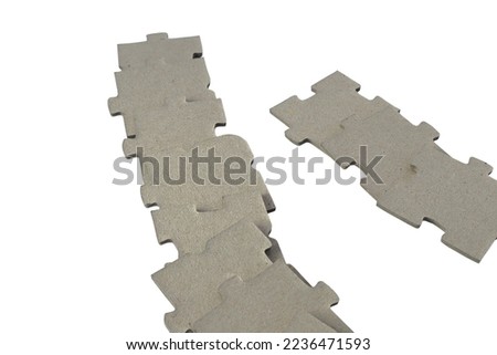 Two rows with gray puzzle pieces. Close up and isolated on a white background.