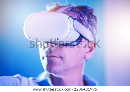 Virtual reality, digital and man in metaverse for future or 3d futuristic simulation technology in a studio. Innovation, cyber and mature person enjoys a gamers experience in high tech vr glasses
