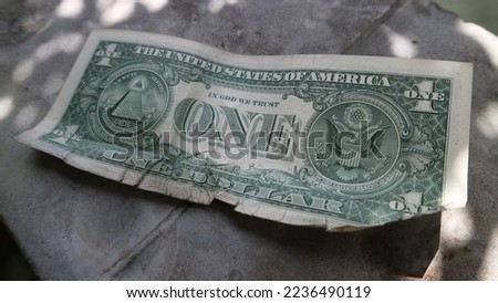 Back view of Crumpled USD cash money on grey background. currency notes in one dollar denomination. Back side of usd money on grey background.