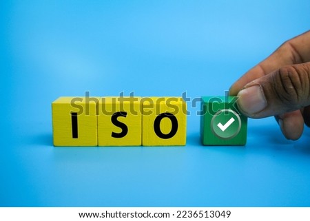 wooden cubes with the letter ISO and the right sign. Corporate regulatory and compliance. Goals achievement and business success. 