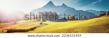 Scenic image of Swiss Alps. Panoramic view of idyllic mountain scenery in the Alps with fresh green meadows during sunset in autumn. grassy field and rolling hills. rural scenery. rich harvest concept Royalty-Free Stock Photo #2236531459