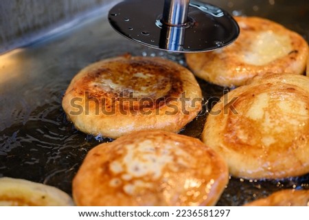 hotteok, Korean Syrup-filled Pancake : Fermented flour dough shaped into balls, filled with a spoonful of brown sugar, and pan-fried in a preheated pan. Brown sugar mixed with cinnamon powder is a com Royalty-Free Stock Photo #2236581297