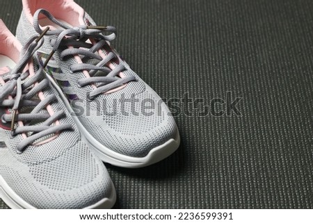 Grey Sport shoes on sport mattress. Indoor workout concept and healthy lifestyle. Sport equipment background.