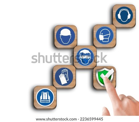 The hand touch at wooden block with the safety icon and icons at workplace safety on wooden blocks isolated white background .Concept of workplace safety Or Safety at work. Royalty-Free Stock Photo #2236599445