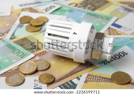Thermostatic Valve Head on Euro Banknotes Background. Increasing Consumption. Cost of Electricity and Expensive Energy Concept. Price Hike. Heating Crisis. Utility Bill Saving, Conservation. Inflation