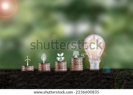 Renewable energy concept Saving shows icons planted on coins and bulbs on soil. alternative energy, environmental protection and finance Investing in energy stocks around the world