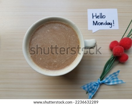 A cup of coffee on a wooden table background.