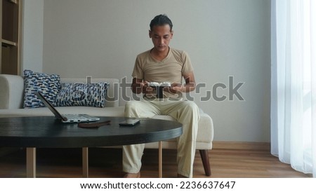 Concept idea men hold and looking family frame while working in the living room at home