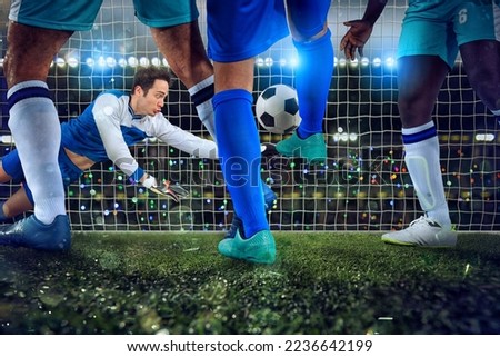 Football scene with soccer players and goalkeeper at the stadium