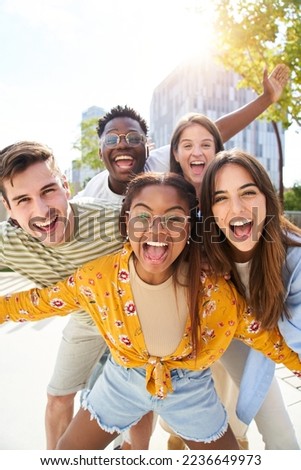 Vertical photo Happy friends looking at Camera and laughing. Smiling Group of people having fun together outdoors. Cheerful community of students university. Lifestyle of multicultural people joyful.
