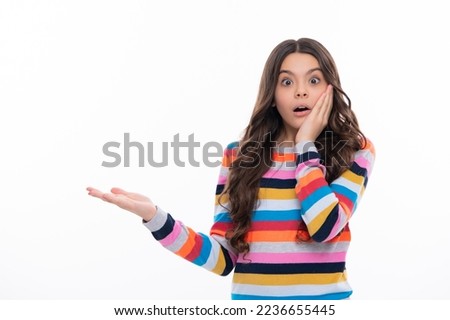 Surprised face, surprise emotions of teenager girl. Close-up portrait of her she nice cute attractive cheerful amazed girl pointing aside on copy space isolated on white background. Royalty-Free Stock Photo #2236655445
