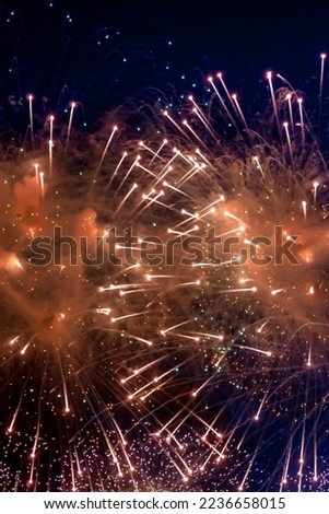 Festive wallpaper concept. Full frame bright firework with sparks, colored stars and nebula on black night sky, comets. Amazing holiday colorful fireworks display on celebration, showing. Copy space