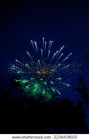 Fireworks with sparks, colored stars and bright nebula on black night sky universe, comets. Amazing holiday colorful firework display on celebration, showing. Festive concept. Copy text space