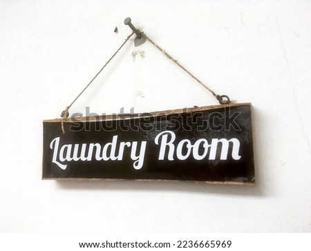 sign with the text "laundry room" hung on the wall in home decor