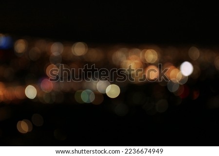 Blurred view of colorful glowing lights outdoors, bokeh effect