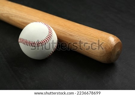 Baseball bat and ball on black background. Sports equipment