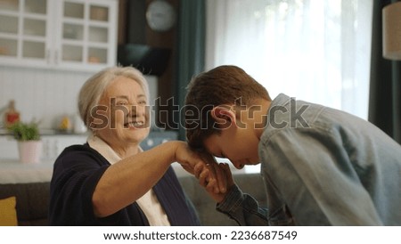 A child kissing his grandmother's hand during the feast (Ramadan or Şeker Bayram). People who adhere to Muslim traditions. The child kisses his grandmother's hand, celebrates the traditional holiday. Royalty-Free Stock Photo #2236687549