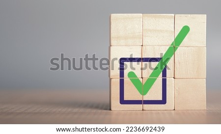 Quality certification and ISO symbol in wood cube with checkmark icon. Ethical corporate. Do the right thing. Corporate regulatory and compliance. Goals achievement and business success.