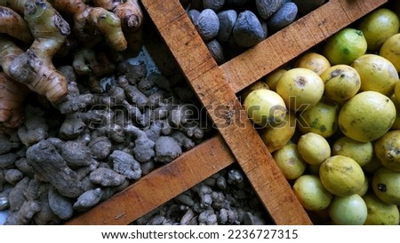Lemon, Ginger, Turmeric and other Spices are sold in a wooden partitioned table at the traditional market.