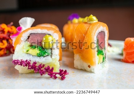 Sushi roll with salmon, avocado and cheese on a white marble plate. photo of salmon sushi in restaurant