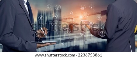 Double exposure engineering team using tablet computer and digital technology interfaces icon on construction cranes background, Technology and business industrial concept. Royalty-Free Stock Photo #2236753861
