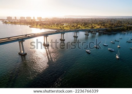 Aerial view of Coronado Bridge in San Diego bay in southern California on a warm sunny day with boats in the bay and cars crossing the bridge Royalty-Free Stock Photo #2236766339