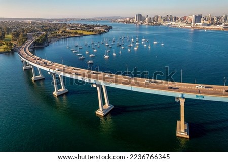 Aerial view of Coronado Bridge in San Diego bay in southern California on a warm sunny day with boats in the bay and cars crossing the bridge Royalty-Free Stock Photo #2236766345