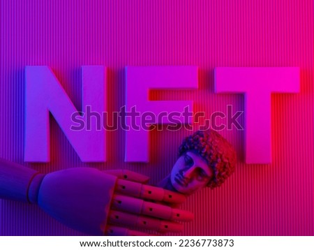 NFT non-fungible token on a bright pink neon background. NFT inscription, antique statue and artificial arm. Cryptocurrency and blockchain concept