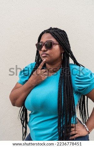 Beautiful black woman with long braids and blue blouse