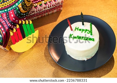 Happy Kwanzaa bento cake and gifts in boxes wrapped in hand-painted paper