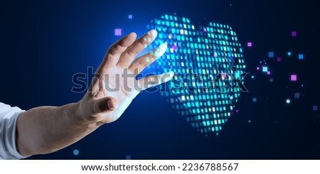 Close up of male hand using abstract glowing blue pixel heart on blurry background. Health, cardiology and game interface concept