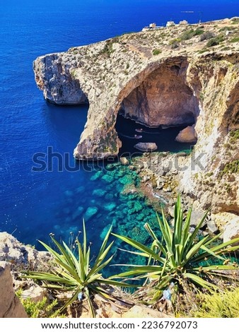 Popular diving and snorkelling spot. Pleasure boat with tourists runs. Ocean water view, rock, cactus, taking vacation picture. Natural arch window in rock. Aerial top view. Beautiful blue sea