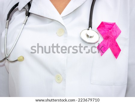 female doctor with  a red ribbon as a symbol of AIDS