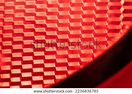 red background - detail of a red traffic warning lamp. The brake light assembly of a modern automobile. Selective focus