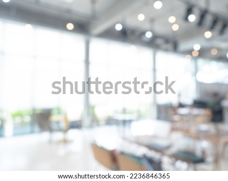 Abstract blurred modern workspace background, white indoor interior office or working space with window and the light with copy space. Blurry backgrounds for advertising and business presentation.