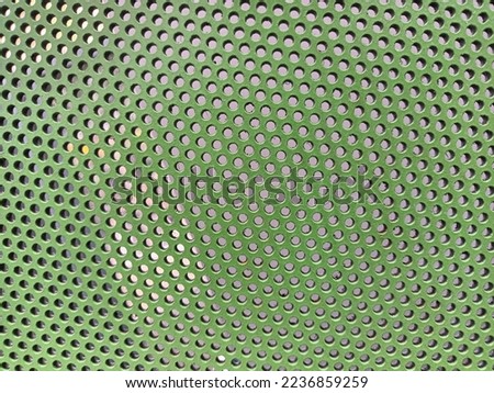 Green metal plate with many holes