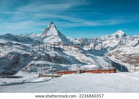 Matterhorn, Switzerland, Winter tourist train with Matterhorn mountain in the background, Zermatt Royalty-Free Stock Photo #2236860357