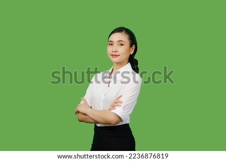 Attractive charming confident asian business woman friendly smiling responsible person arms crossed wear casual white shirt black pants isolated green color background