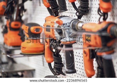 A professional tool for work, repair and construction in the store. Sale of wired power tools and battery powered equipment in the shop Royalty-Free Stock Photo #2236896565
