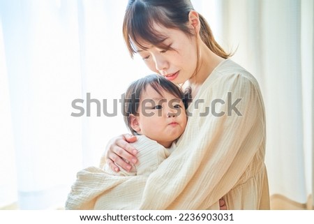Parent and child hugging in the room Royalty-Free Stock Photo #2236903031