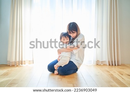 Parent and child hugging in the room Royalty-Free Stock Photo #2236903049
