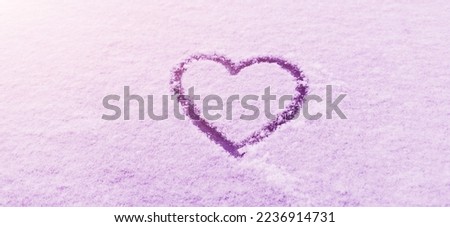 Heart symbol drawn on the snow, on winter day. Romance. Valentine's Day.
