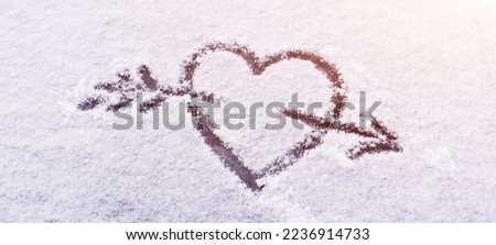 heart in the snow with an arrow is a symbol of eternal love and celebration - Valentine's Day