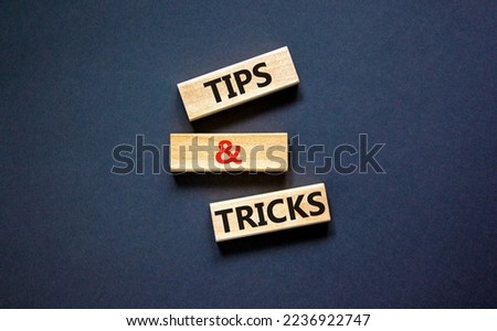 Tips and tricks symbol. Concept words Tips and tricks on wooden blocks. Beautiful black table, black background. Business, tips and tricks concept. Copy space.